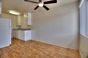 Sunnyvale apartment for rent - an empty living room with a kitchen and a ceiling fan