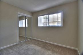 Sunnyvale apartment for rent - an empty bedroom with a window and a door to a closet