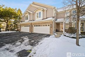 Rolling Meadows townhouse for rent - A house with a snow-covered driveway in front.