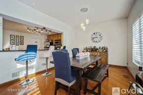Rolling Meadows townhouse for rent - A dining room with a wooden table and blue chairs.