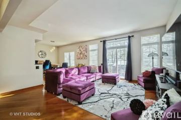 Rolling Meadows townhouse for rent - A living room with a purple couch and a white rug.
