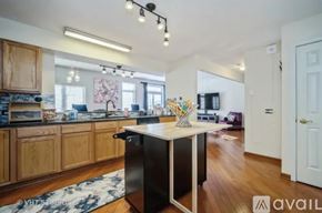 Rolling Meadows townhouse for rent - A kitchen with wooden cabinets and a black island.