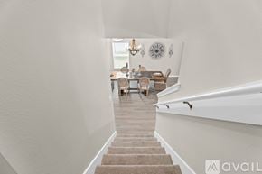 Orange Park house for rent - A hallway with a staircase leading to a dining area.