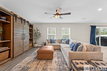 Orange Park house for rent - A living room with a brown rug and a white sofa.