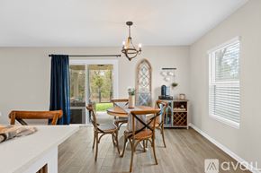 Orange Park house for rent - A dining room with a wooden table and chairs.