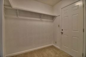 Sunnyvale apartment for rent - A white door is on the right side of a room with a carpeted floor.