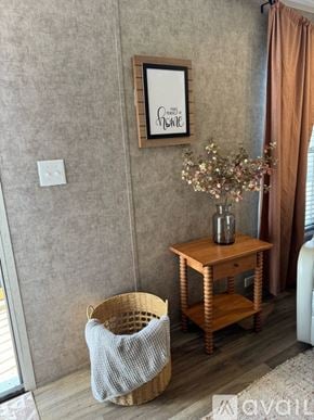 Selma apartment for rent - A room with a table, a basket, and a vase with flowers.