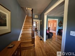 Washington house for rent - Two chairs are on a porch in front of a red building.