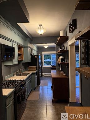 Washington house for rent - A kitchen with a stove top oven and a counter top.