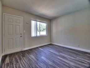 Mountain View apartment for rent - an empty living room with a door and a window