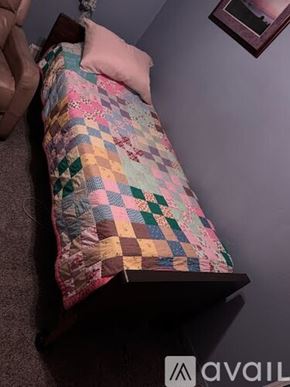 Tuolumne apartment for rent - A person is holding a quilt with a patchwork design.