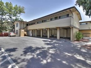 Palo Alto apartment for rent - A parking lot in front of a two-story building.
