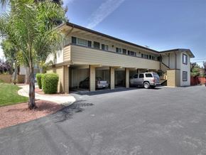 Palo Alto apartment for rent - A two-story building with a garage and a tree in front.