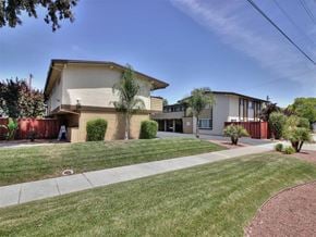 Palo Alto apartment for rent - A building with a green lawn in front.