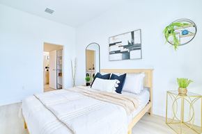 Fort Lauderdale apartment for rent - A bedroom with a large bed and a mirror on the wall.