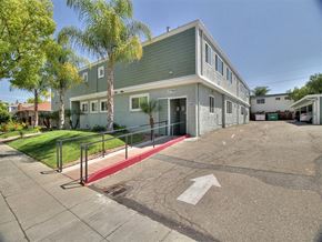Campbell apartment for rent - A parking lot with a building and a red painted area.