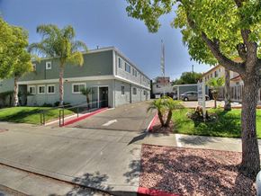 Campbell apartment for rent - A building with a green roof and a red and white striped curb in front of it.