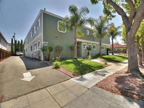 Campbell apartment for rent - A street view of a green building with a white arrow on the road.