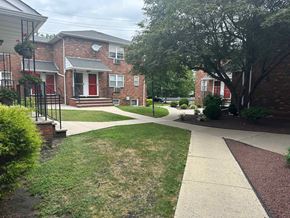 Rutherford apartment for rent - A residential area with a brick house and a red door.