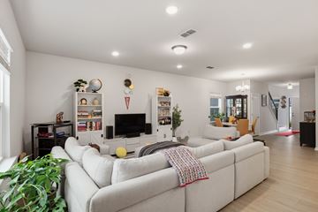 Raleigh house for rent - A living room with a white couch and a television.