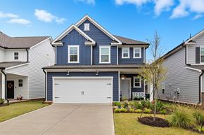 Raleigh house for rent - A blue house with a white garage door in front.