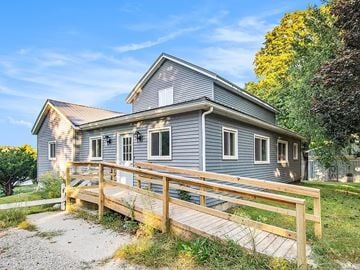 Hubbardston house for rent - A house with a grey exterior and a wooden deck.