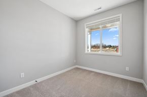 River Falls house for rent - A room with a window showing a view of trees and a blue sky.