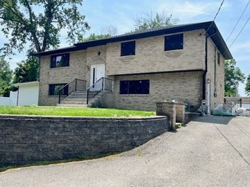 Pequannock house for rent - A two-story house with a white door and black railings.