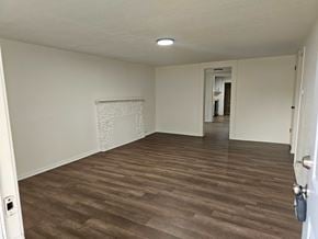 Choctaw house for rent - A room with a light brown floor and white walls.