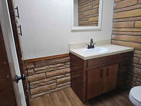 Choctaw house for rent - A bathroom with a white sink and a brown cabinet.