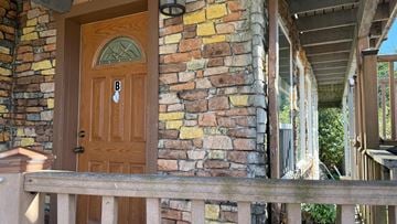 Sitka apartment for rent - A brown door with a glass window is on a stone wall.