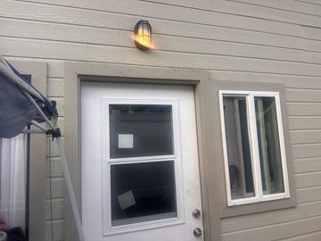 Kailua-Kona apartment for rent - A white door with a window above it and a small light on the wall.