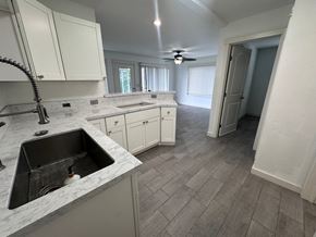 Kailua-Kona apartment for rent - A kitchen with a marble countertop and white cabinets.