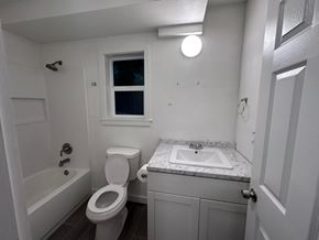 Kailua-Kona apartment for rent - A white toilet sits next to a sink in a small bathroom.
