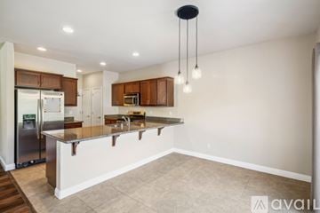 Reno house for rent - A kitchen with a refrigerator, cabinets, and a countertop.