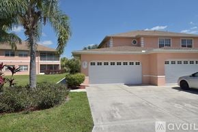 Lehigh Acres apartment for rent - A house with a white car parked in front of it.