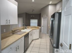 Lehigh Acres apartment for rent - A spacious room with a ceiling fan and sliding glass doors.
