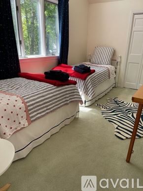Freeport house for rent - A bedroom with two beds and a zebra rug on the floor.