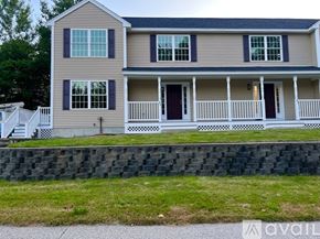 Milford townhouse for rent - A two-story house with a front porch and a white picket fence.