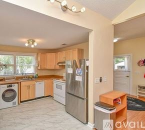 St. Augustine house for rent - A kitchen with a refrigerator and a washing machine.