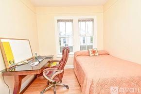 St. Augustine house for rent - A bedroom with a bed, desk, chair, and window.