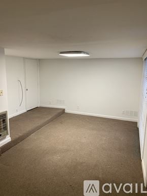 Berry Hill house for rent - A carpeted room with a white wall and a door.