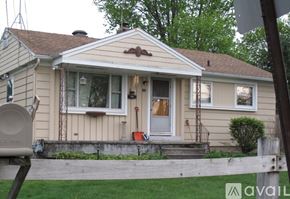 Syracuse house for rent - A house with a white door and a small porch.