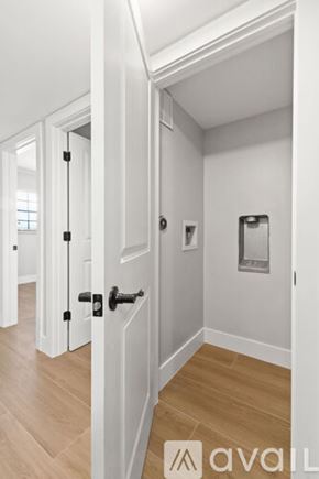 North Palm Beach apartment for rent - A hallway with a wooden floor and white walls.