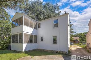Kansas City house for rent - A white two-story house with a balcony on the upper floor.