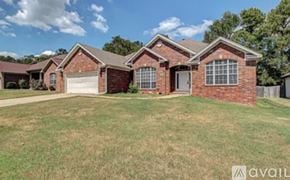 Little Rock house for rent - A house with a red brick exterior and a white garage door is for sale.