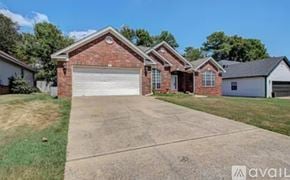 Little Rock house for rent - A house with a brick facade and a white garage door is for sale.