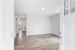 Knoxville townhouse for rent - A spacious room with wooden flooring and white walls.
