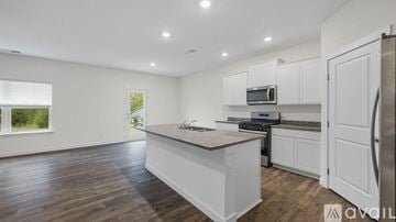 Cleveland house for rent - A kitchen with white cabinets and a wooden floor.