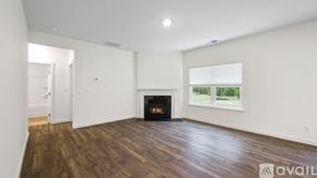 Cleveland house for rent - A spacious room with a fireplace and wooden flooring.
